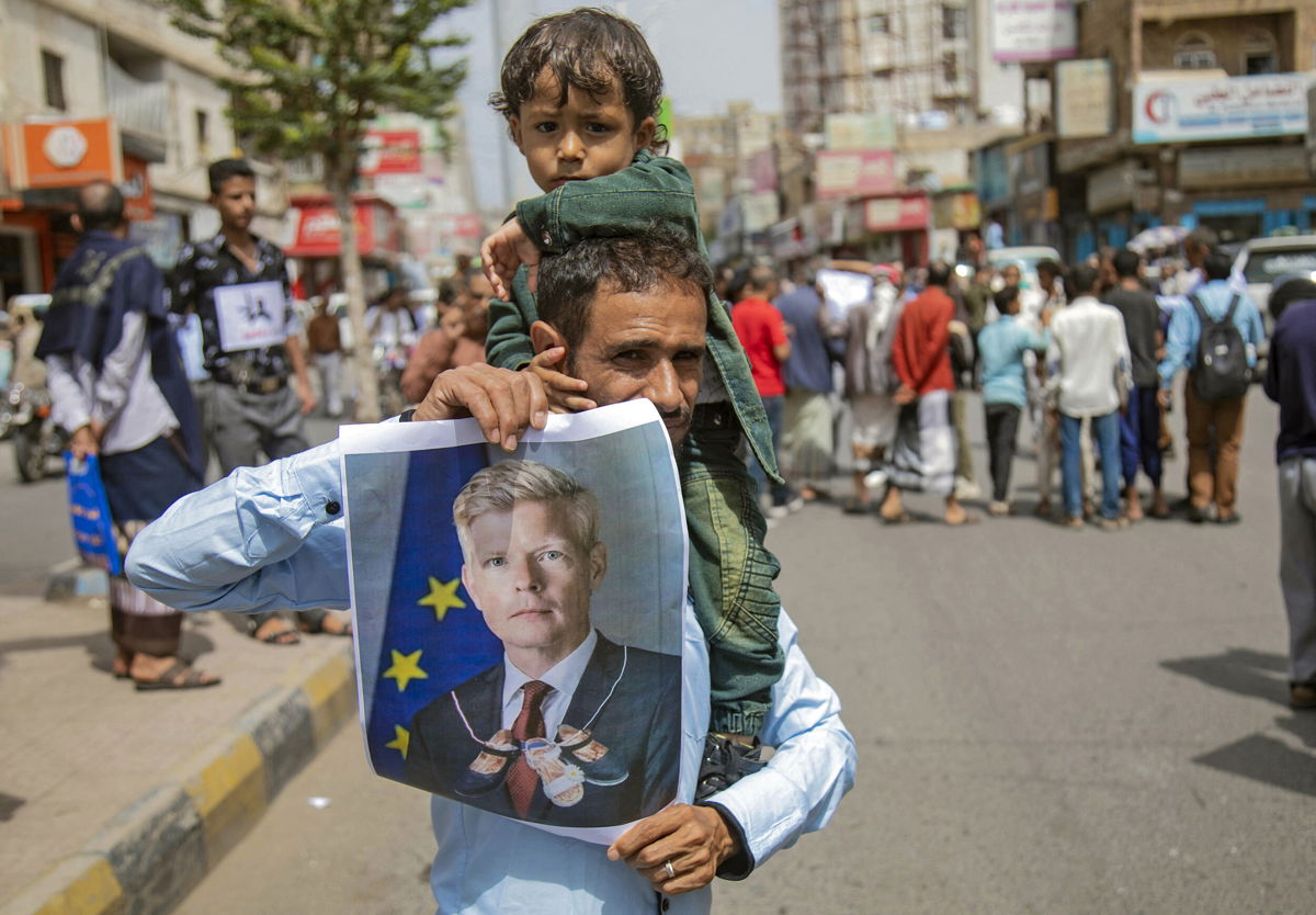 <i>Ahmad Al-Basha/AFP/Getty Images</i><br/>Yemeni demonstrators hold a portrait of UN special envoy Hans Grundberg during a protest demanding the end of a years-long blockade of the area imposed by Yemen's Houthi rebels on the city of Taiz