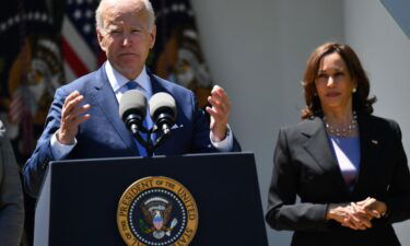 US Vice President Kamala Harris (R) listens as US President Joe Biden delivers remarks in the Rose Garden of the White House in Washington