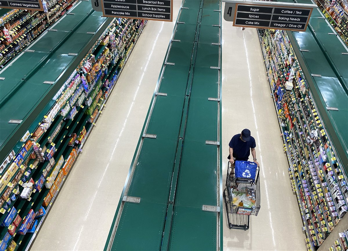 <i>Saul Loeb/AFP/Getty Images</i><br/>People shop at a supermarket in Arlington