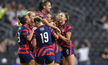 Alex Morgan celebrating with teammates after scoring the 2022 Concacaf W Championship-winning goal.