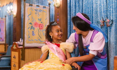 A child is outfitted by an employee at Disney's Bibbidi Bobbidi Boutique at Disneyland in Anaheim