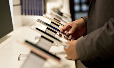 A shopper looks over a display of iPhones at a T-Mobile store in Chicago
