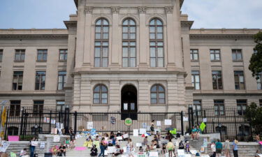 A small group gathers at the steps of the Georgia State Capitol protesting the overturning of Roe v. Wade on Sunday