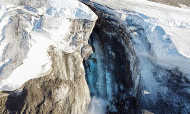 A powerful river of meltwater flowing out to the ocean can be seen between a canyon of ice in northern Greenland amid abnormal warmth.