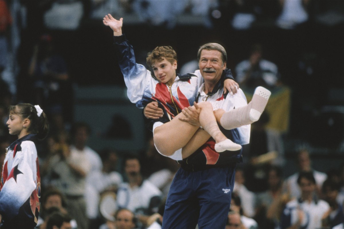 <i>David Madison/Getty Images</i><br/>Kerri Strug of the United States is carried by coach Bela Karolyi during the team competition of the Women's Gymnastics event of the 1996 Summer Olympic Games held on July 23