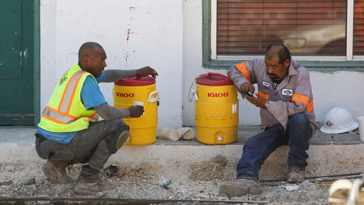<i>Lisa Krantz/Reuters</i><br/>Construction workers Anthony Harris and Angel Gonzalez take a water break during an excessive heat warning in San Antonio