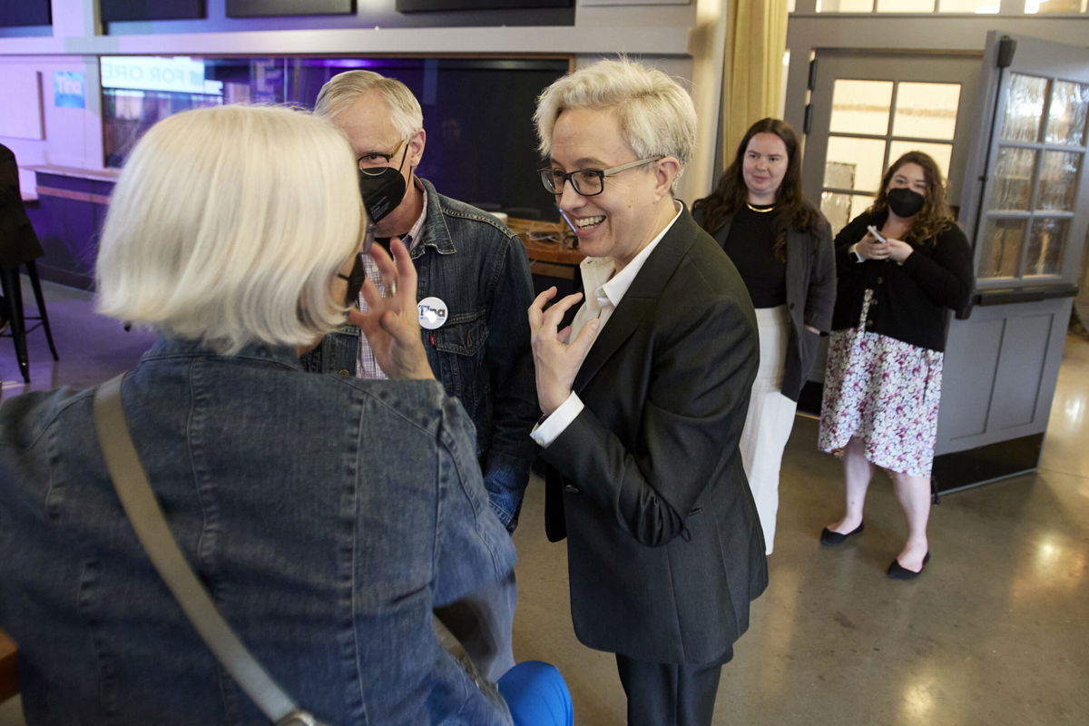 <i>Craig Mitchelldyer/AP</i><br/>Oregon Democratic gubernatorial candidate Tina Kotek (C) speaks to supporters before the results of Oregon's primary election are announced in May. A historic number of LGBTQ candidates are running for office this year.