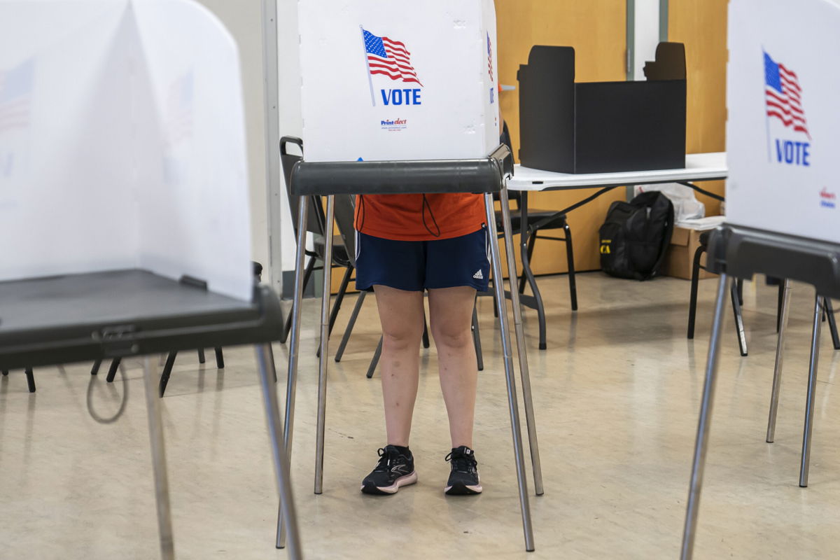 <i>Nathan Howard/Getty Images</i><br/>A voter casts their ballot at a polling place during the midterm primary election on July 19 in Baltimore