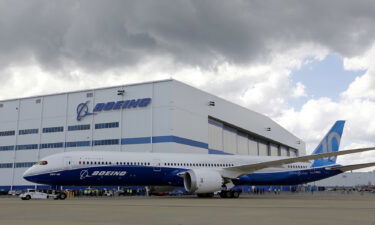 Boeing employees stand near the new Boeing 787-10 Dreamliner at the company's facility in South Carolina after conducting its first test flight at Charleston International Airport in North Charleston