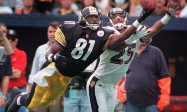 Johnson dives for a pass as the Baltimore Ravens' DeRon Jenkins defends him during a game on October 18