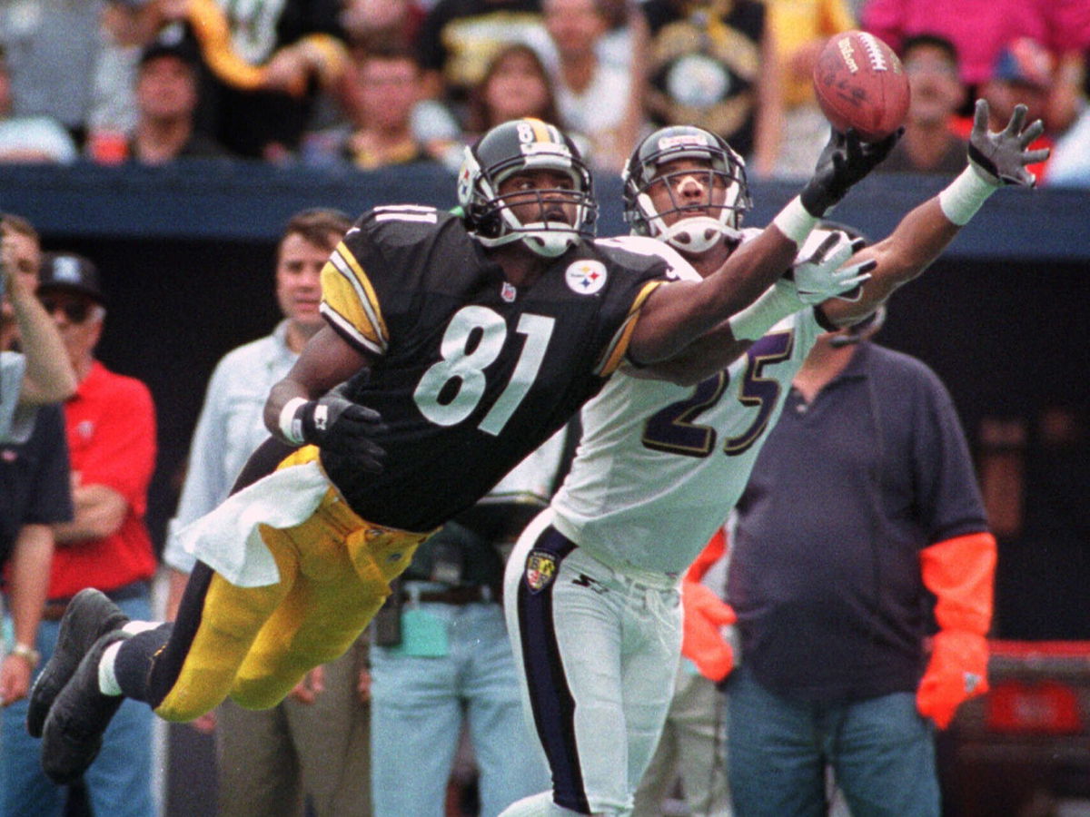 <i>Roberto Borea/AP</i><br/>Johnson dives for a pass as the Baltimore Ravens' DeRon Jenkins defends him during a game on October 18