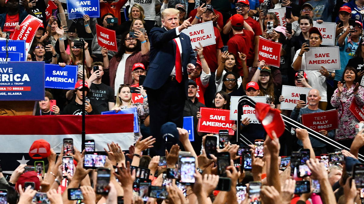 <i>Patrick T. Fallon/AFP/Getty Images/FILE</i><br/>People in the crowd cheer as former President Donald Trump walks on stage during a 