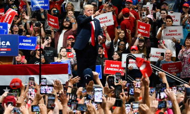 People in the crowd cheer as former President Donald Trump walks on stage during a "Save America" rally in Anchorage