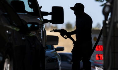 A customer holds a fuel nozzle at a Shell gas station in Hercules