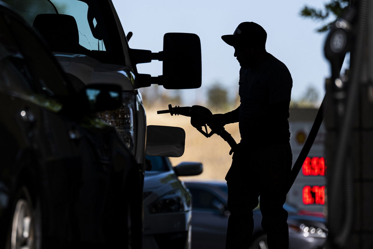 <i>David Paul Morris/Bloomberg/Getty Images</i><br/>A customer holds a fuel nozzle at a Shell gas station in Hercules