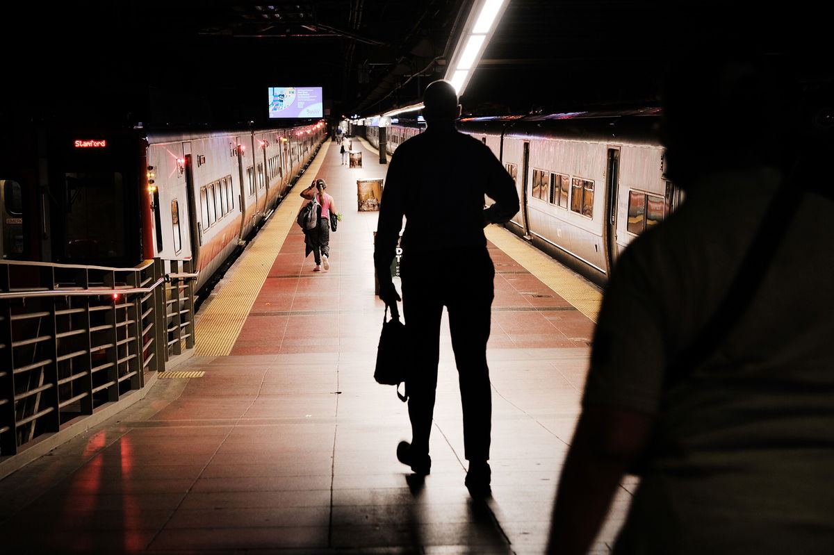 <i>Spencer Platt/Getty Images</i><br/>People walk to get a train in Grand Central Terminal in August 2021 in New York City. The economy is on shaky ground: stock markets have been selling off