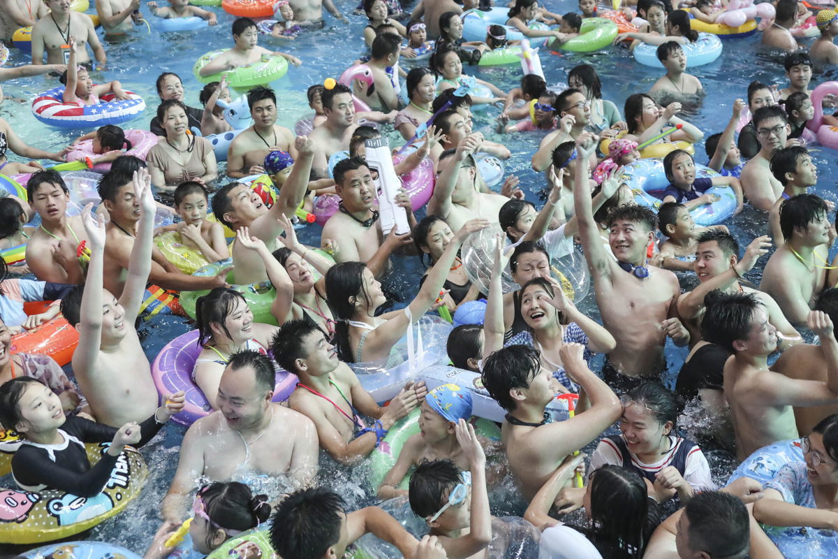 <i>Stringer/AFP/Getty Images</i><br/>People cool off in a pool at a water park in Huaian