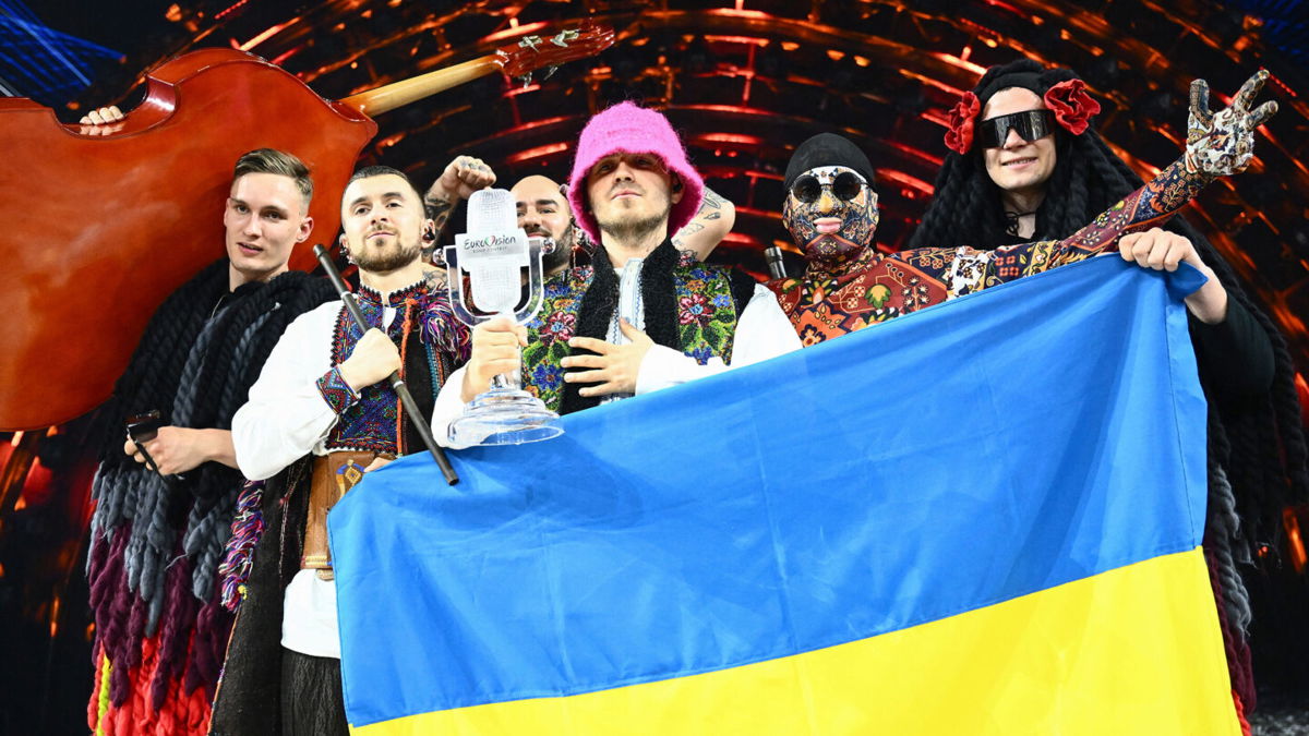 <i>Marco Bertorello/AFP/Getty Images</i><br/>Members of the band Kalush Orchestra pose onstage with the winner's trophy and Ukraine's flags after winning on behalf of Ukraine the Eurovision Song Contest in May. The UK will host next year's Eurovision Song Contest on behalf of Ukraine.