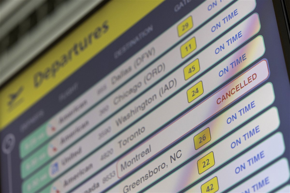 <i>Angus Mordant/Bloomberg/Getty Images</i><br/>A cancelled flight on a departures board at LaGuardia Airport (LGA) in the Queens borough of New York