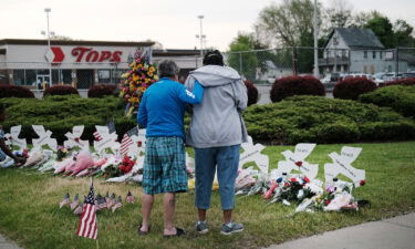 People gather at a memorial for the shooting victims outside of Tops market in Buffalo