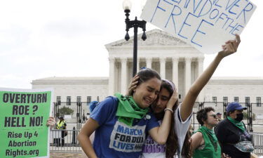 Abortion rights activists Carrie McDonald  (L) and Soraya Bata react to the Dobbs v Jackson Women's Health Organization ruling which overturns the landmark abortion Roe v. Wade case in front of the U.S. Supreme Court on June 24 in Washington