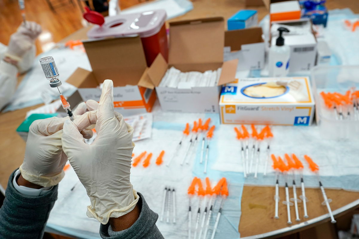 <i>Mary Altaffer/AP/FILE</i><br/>A nurse preps a syringe at a pop-up Covid-19 vaccination site in the New York borough of Staten Island in April 2021. Covid-19 cases are increasing across the United States once again.