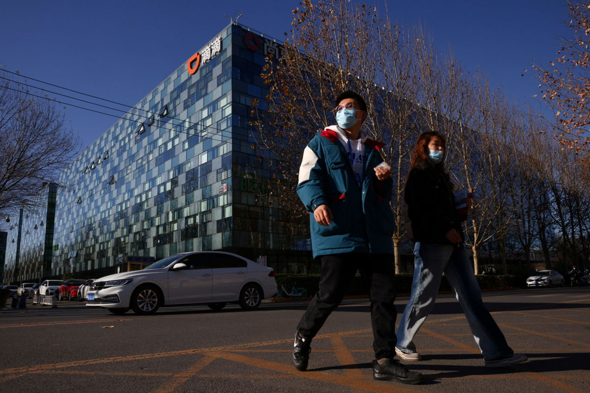 <i>Thomas Peter/Reuters</i><br/>People walk past the headquarters of the Chinese ride-hailing service Didi in Beijing