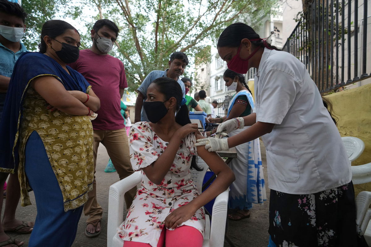 <i>Mahesh Kumar A/AP</i><br/>A health worker administers a Covid-19 vaccine in Hyderabad