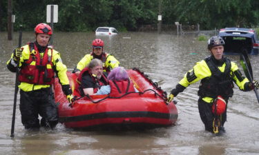 St. Louis firefighters seen bringing homeowners to dry land following flooding on Tuesday