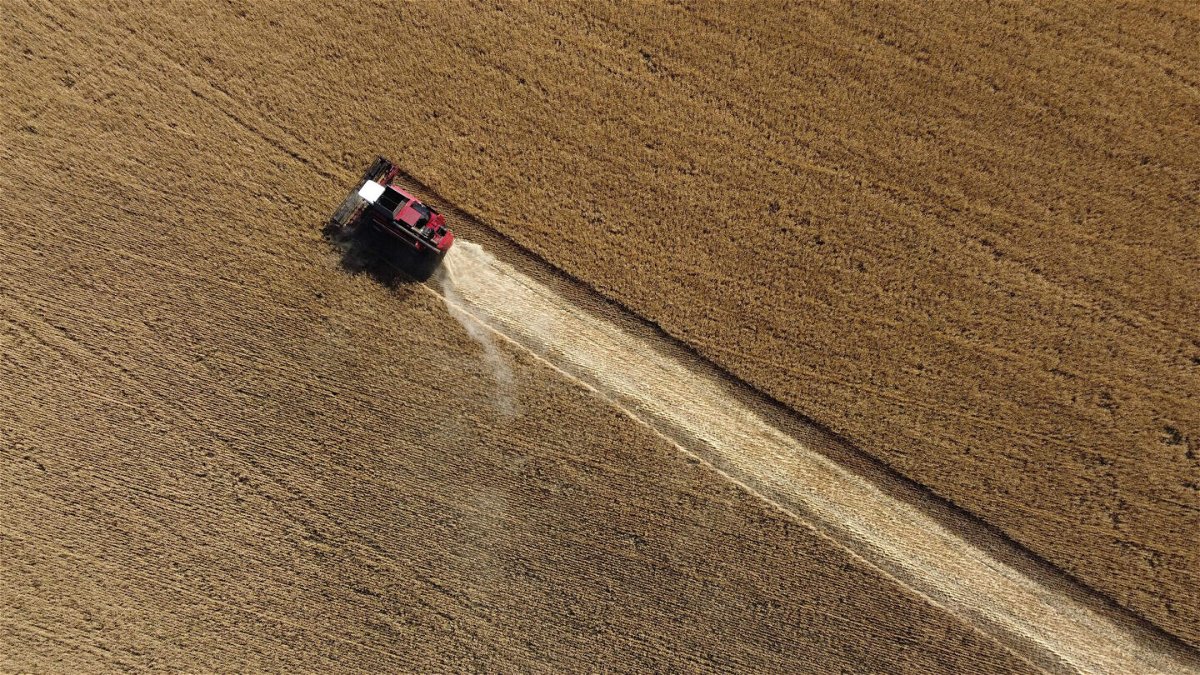 <i>Miguel Medina/AFP/Getty Images</i><br/>This aerial picture taken on July 7 shows a farmer harvesting wheat near Kramatosk in the Donetsk Oblast