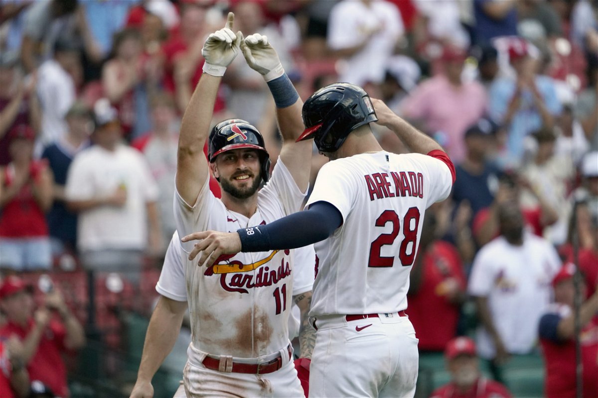 St. Louis Cardinals' Paul DeJong (11) is congratulated by teammate Nolan Arenado (28) after hitting a three-run home run during the eighth inning of a baseball game against the New York Yankees Sunday, Aug. 7, 2022, in St. Louis. (AP Photo/Jeff Roberson)