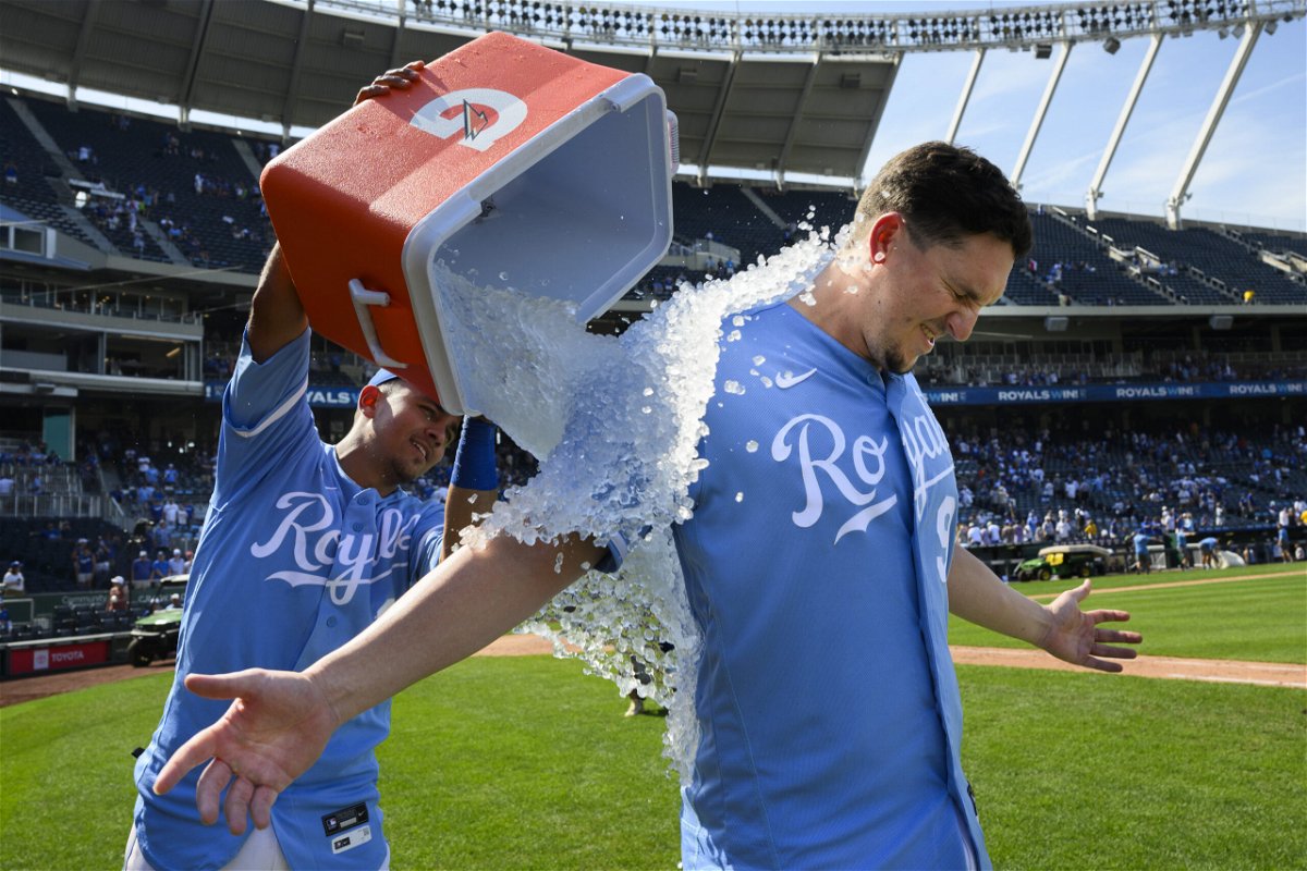 Kansas City Royals' Vinnie Pasquantino is doused with ice water by teammate Nicky Lopez, left, after they beat the Los Angeles Dodgers 4-0 in a baseball game, Sunday, Aug. 14, 2022, in Kansas City, Mo. 