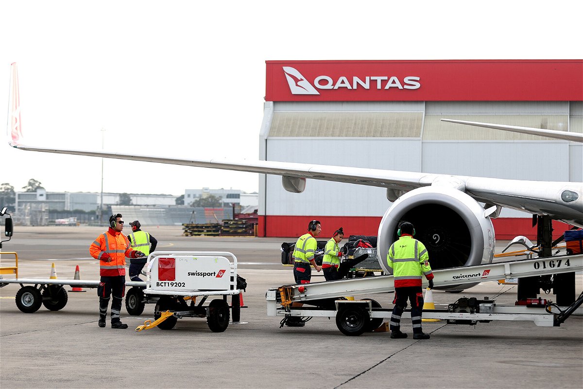 <i>Brendon Thorne/Bloomberg/Getty Images/FILE</i><br/>Members of the ground crew work next to an aircraft operated by Qantas Airways Ltd. at Sydney Airport in Sydney