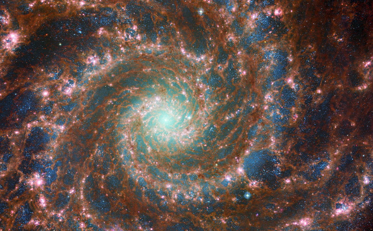 <i>NASA/ESA</i><br/>M74 shines at its brightest in this combined optical/mid-infrared image
