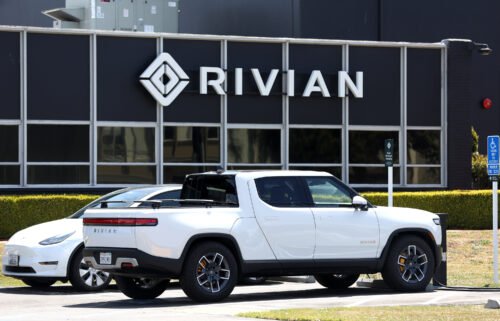 A Rivian electric pickup truck sits in a parking lot at a Rivian service center on May 9