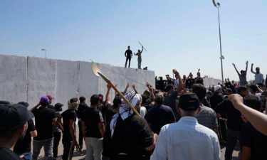 Supporters of Muqtada al-Sadr try to remove concrete barriers in the Green Zone area of Baghdad on August 29.