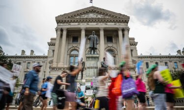 Abortion rights protesters march outside the Indiana State Capitol building. Near-total abortion ban in Indiana passed the GOP-controlled Senate and now heads to the State House.