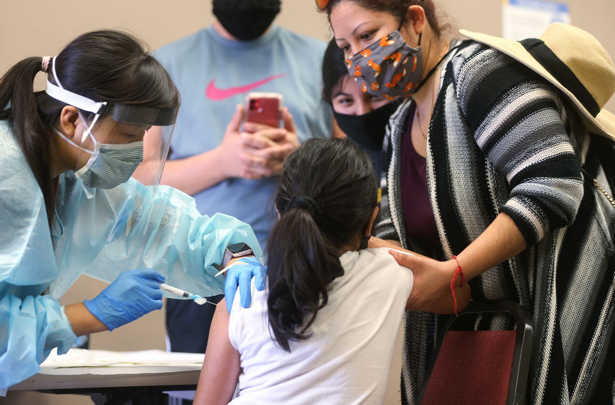 <i>Mario Tama/Getty Images</i><br/>A girl receives the flu vaccination shot from a nurse on October 14