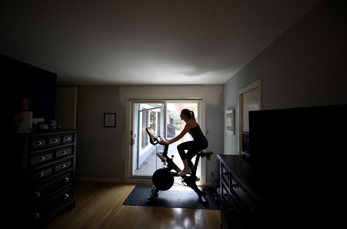 <i>Ezra Shaw/Getty Images</i><br/>Jen Van Santvoord rides her Peloton exercise bike at her home in San Anselmo