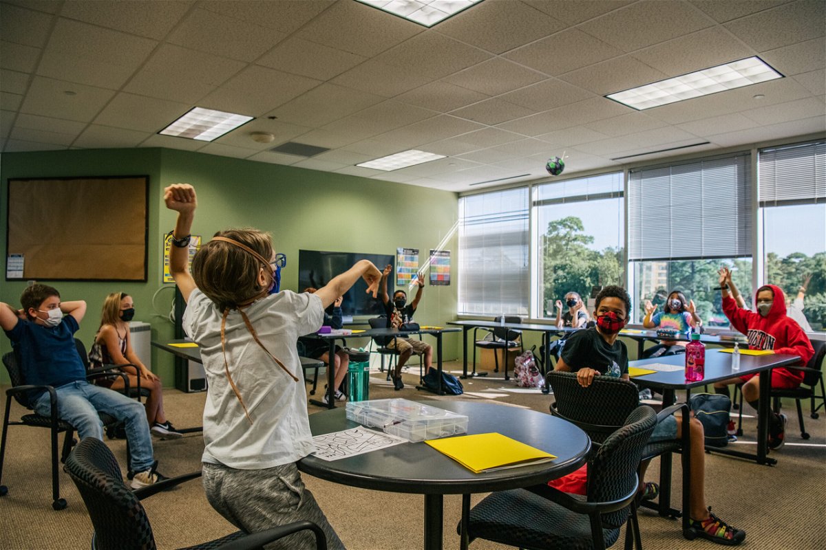 <i>Brandon Bell/Getty Images</i><br/>Most US public schools plan to keep masks optional for the start of classes. Children participate in a class activity at the Xavier Academy on August 23