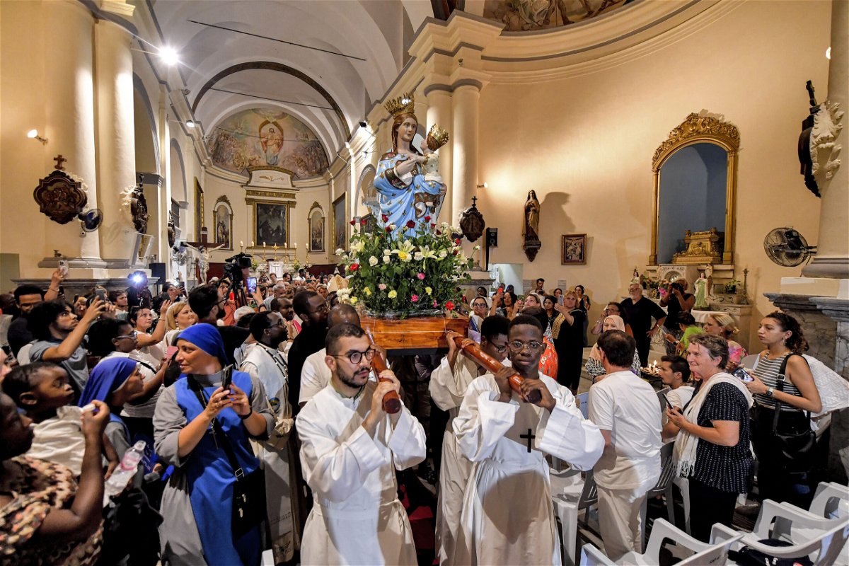 <i>Fethi Belaid/AFP/Getty Images</i><br/>Worshippers carry the shrine of the Madonna of Trapani during the procession at the Saint-Augustin and Saint-Fidèle church in Tunisia on August 15.