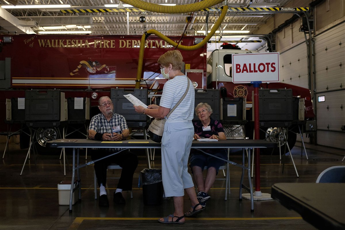 <i>Alex Wroblewski/Getty Images</i><br/>Poll workers and voters participate during Wisconsin's state primary day on August 9 in Waukesha