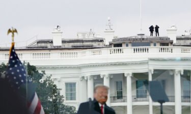 Members of the Secret Service patrol from the roof of the White House as President Donald Trump speaks to supporters from The Ellipse on January 6