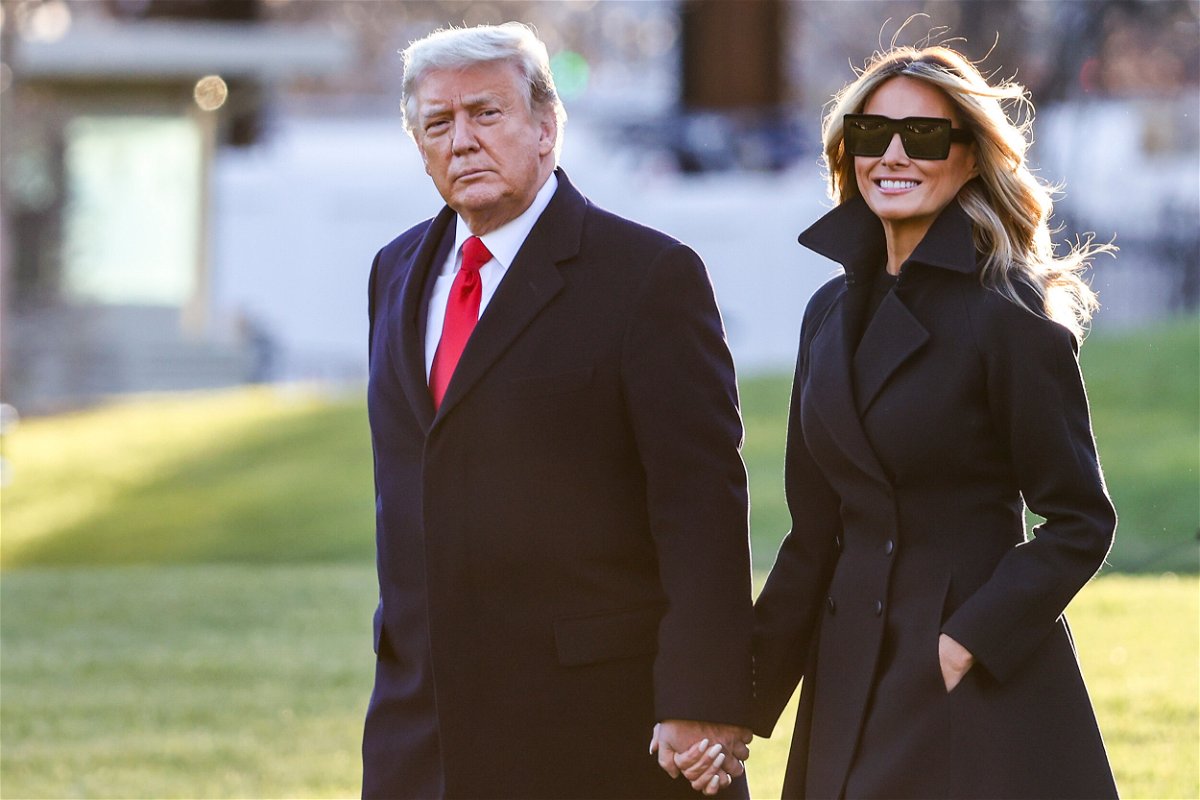 <i>Tasos Katopodis/Getty Images/FILE</i><br/>Then-President Donald Trump and first lady Melania Trump walk are seen here in December 2020. Trump donors help underwrite portraits of the former President and former first lady at the National Portrait Gallery.