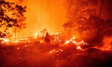 A firefighter battles flames during the Creek Fire in Madera County