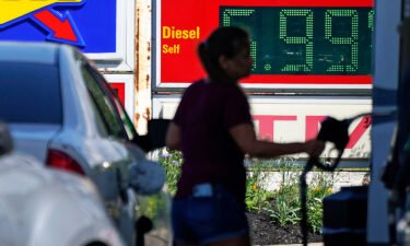 Prices in the US stayed the same last month. A woman pumps gas at a Sunoco mini-mart in Independence