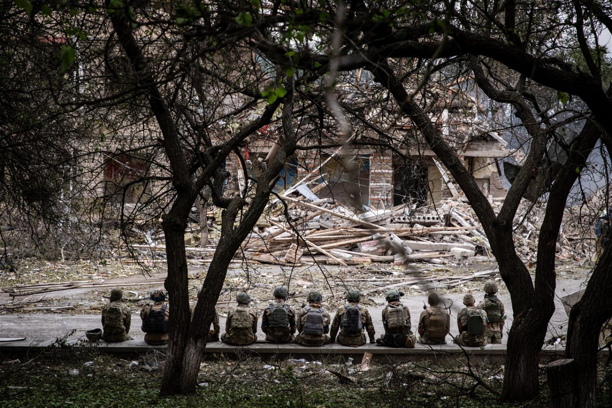 <i>Alex Chan Tsz Yuk/SOPA Images/LightRocket/Getty Images</i><br/>Ukrainian soldiers sit at the shelling scene of a destroyed school in Kramatorsk. Amnesty International said it 