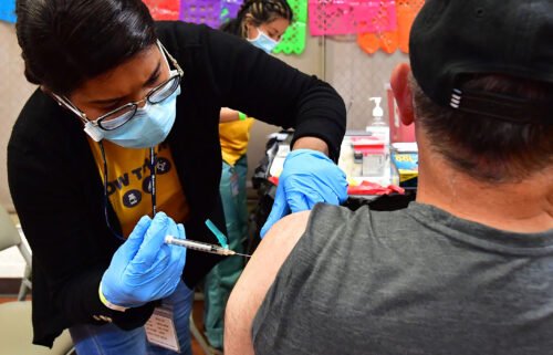Registered Nurse Mariam Salaam administers the Pfizer booster shot at a Covid vaccination and testing site in Los Angeles on May 5. The Biden administration will stop buying Covid-19 vaccines