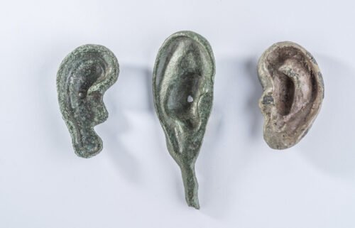 A collection of three ear-shaped votive offerings unearthed at San Casciano dei Bagni.