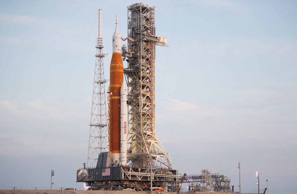 <i>Joel Kowsky/NASA</i><br/>NASA's Space Launch System (SLS) rocket with the Orion spacecraft aboard is seen atop the mobile launcher as it is rolled up the ramp at Launch Pad 39B